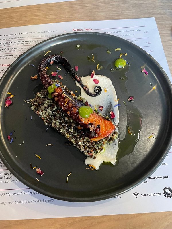 Octopus served over a salad of vegetables, quinoa, beluga lentils, and tarama mousse